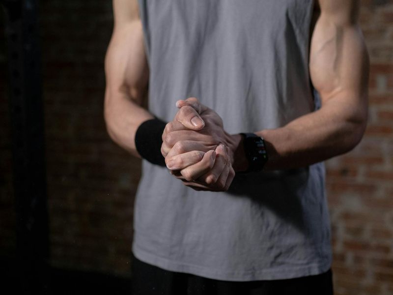 A close-up shot of an athletic person's hands clasped, showing focus and determination.